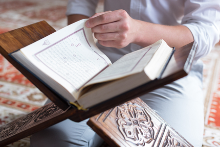Young Muslim Man Reading The Koranの写真素材
