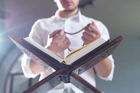 Young Muslim Man Reading The Koranの写真素材