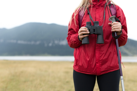 Woman Traveler with Backpack hiking in Mountains with beautiful summer landscape on background mountaineering sport lifestyle conceptの写真素材