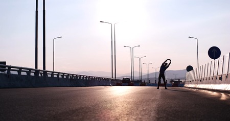 Running at sunrise man exercising for marathon and workout fitnessの写真素材