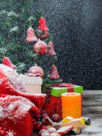 Christmas candles and fir tree branches on a wooden background with toysの写真素材