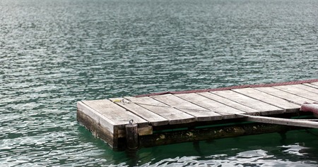 A Day At The Lake. Wooden dock overlooking a gorgeous lake in the wildernessの写真素材