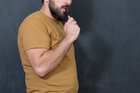 close up portrait of a man smoking an e-cigaretteの写真素材