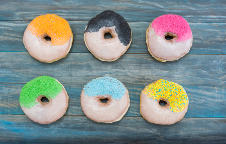 fresh donuts on wooden table topの写真素材