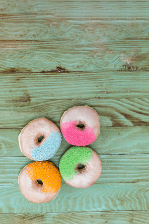 fresh donuts on wooden table topの写真素材