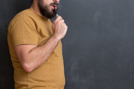 close up portrait of a man smoking an e-cigaretteの写真素材