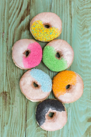 fresh donuts on wooden table topの写真素材
