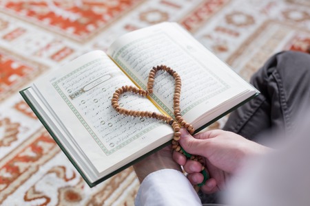 a muslim man is reading quran.の写真素材