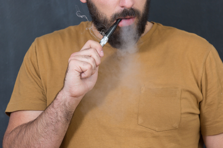 close up portrait of a man smoking an e-cigaretteの写真素材