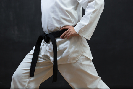Karate Fighter in white Kimono Isolated on Black with Copy spaceの写真素材