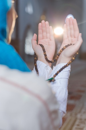 hand holding a muslim rosaryの写真素材