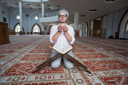 a muslim man is reading quran.のeditorial素材