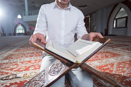 Young Muslim Man Reading The Koranの写真素材