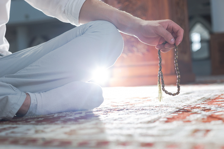 hand holding a muslim rosaryの写真素材