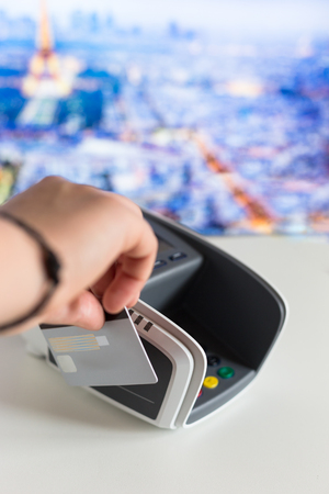 Credit card in hand and terminal in shopの写真素材