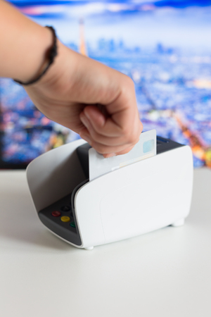 Credit card in hand and terminal in shopの写真素材