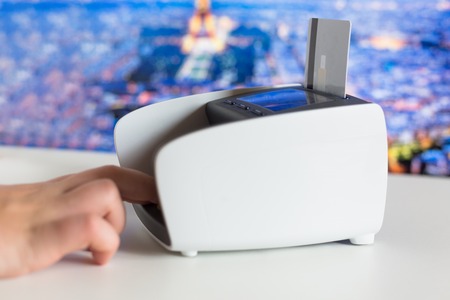 Female hand with credit card and bank terminalの写真素材