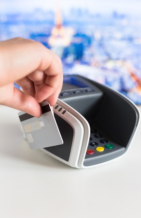 Female hand with credit card and bank terminalの写真素材
