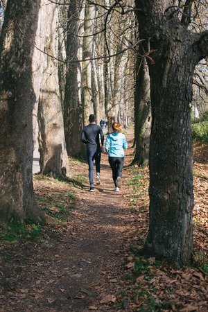Trail running marathon athlete outdoors sunrise couple training for fitness and healthy lifestyleの写真素材