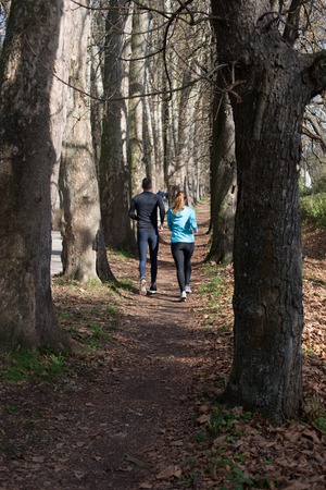 Trail running marathon athlete outdoors sunrise couple training for fitness and healthy lifestyleの写真素材