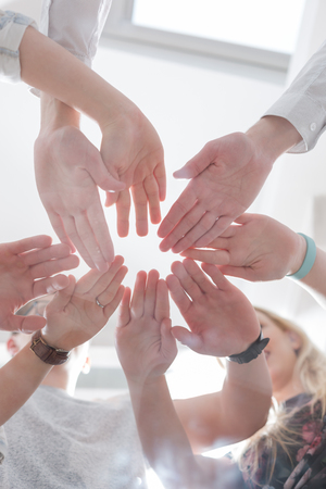 Close up image of young students making a stack of hands.の写真素材