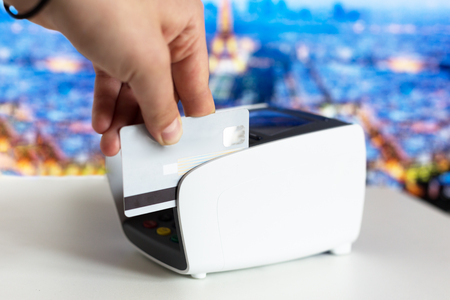 Female hand with credit card and bank terminalの写真素材