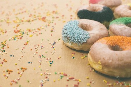 Colorful donuts on the background of beige kraft paper, retro filterの写真素材