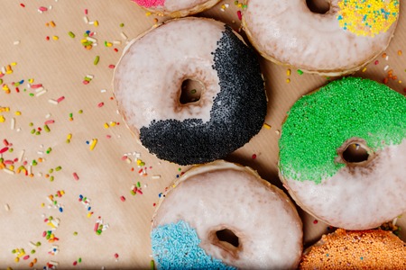 Colorful donuts on the background of beige kraft paperの写真素材