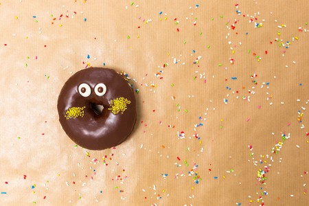 Colorful donuts on the background of beige kraft paperの写真素材