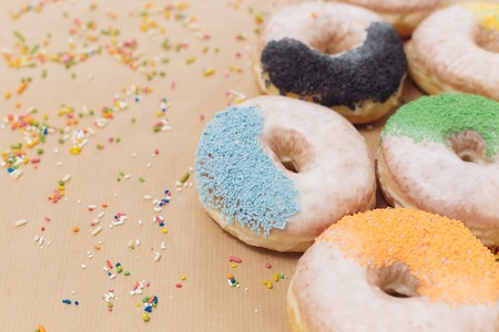 Colorful donuts on the background of beige kraft paperの写真素材