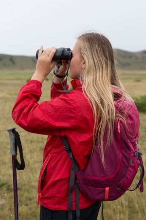 Woman Traveler with Backpack hiking in Mountains with beautiful summer landscape on background mountaineering sport lifestyle conceptの写真素材