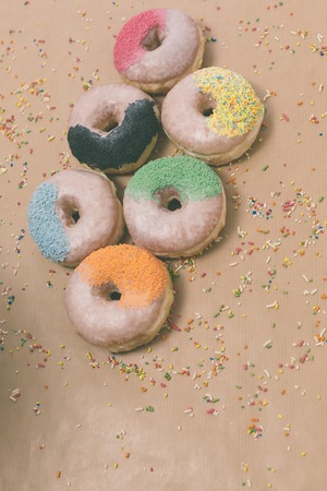 Colorful donuts on the background of beige kraft paper, retro filterの写真素材