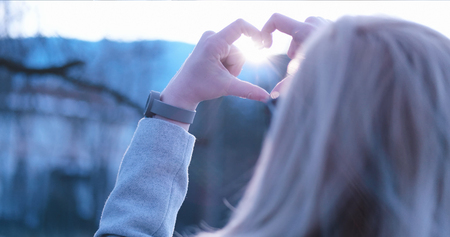 Beautiful caucasian blonde woman  showing heart sign with fingers, valentine day concept
loveの写真素材