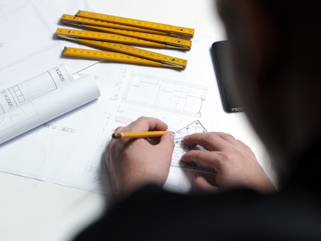 Business man draw buildings and present his architectural projectの写真素材