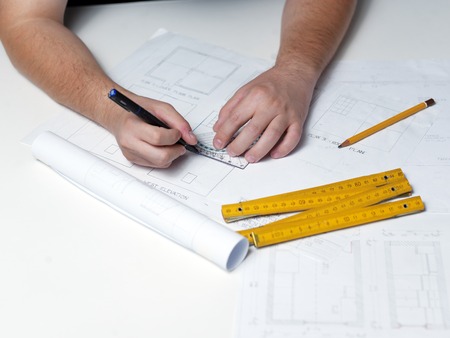 Business man draw buildings and present his architectural projectの写真素材