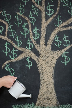 Dollar tree painted on chalkboard growing from the headの写真素材
