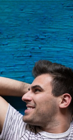 Young man relaxing on carpetの写真素材