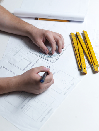 Business man draw buildings and present his architectural projectの写真素材