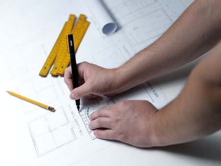 Business man draw buildings and present his architectural projectの写真素材