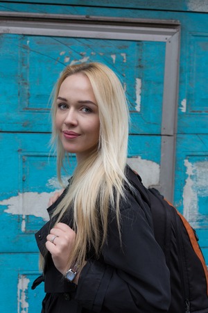 Beautiful young woman smiling against wooden backgroundの写真素材