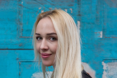 Beautiful young woman smiling against wooden backgroundの写真素材