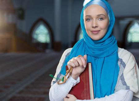 Muslim girl with Holy Book Koran