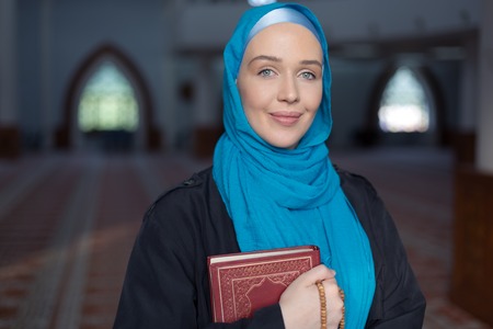 Muslim girl with Holy Book Koranの写真素材