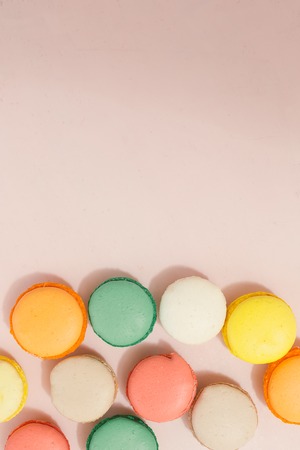 Colorful france macarons on pink background - copy spaceの写真素材