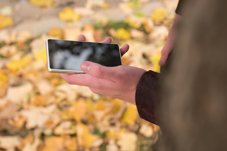 Man using cellphone outdoors.の写真素材