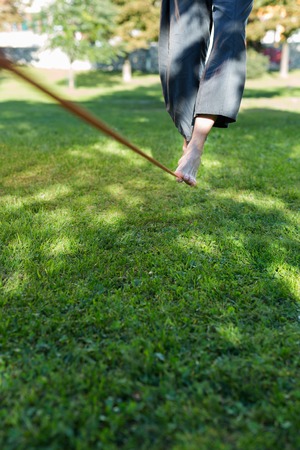 Portrait of man on slackline. Slacklining is a practice in balanceの写真素材