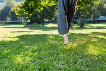 Portrait of man on slackline. Slacklining is a practice in balanceの写真素材