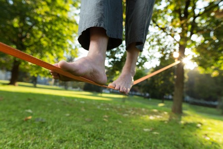 Slackline. Close up of foots on the ropeの写真素材
