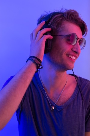 dj with headphones in nightclub party scene, toned imageの写真素材