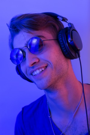 dj with headphones in nightclub party scene, toned imageの写真素材
